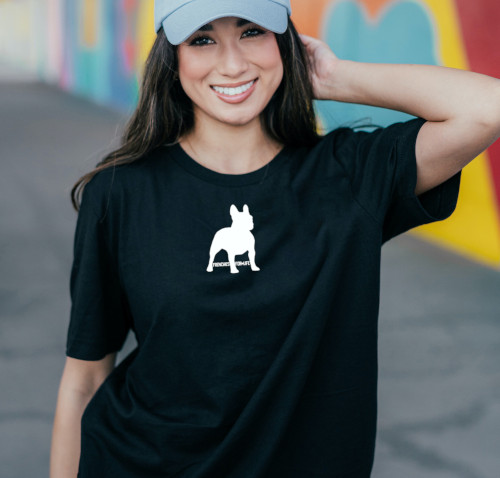 Woman modeling a black t-shirt with the frenchie graphic print design.